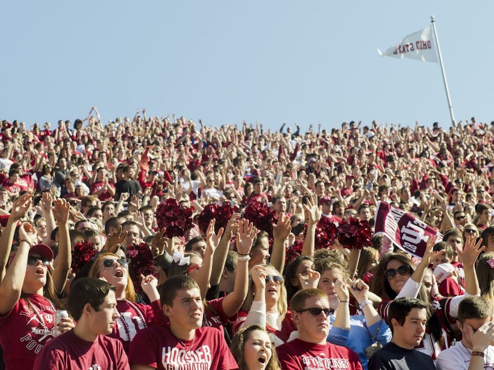 Hoosier fans sing the IU Fight Song during IU's loss to Wisconsin on Saturday afternoon at Memorial Stadium.
