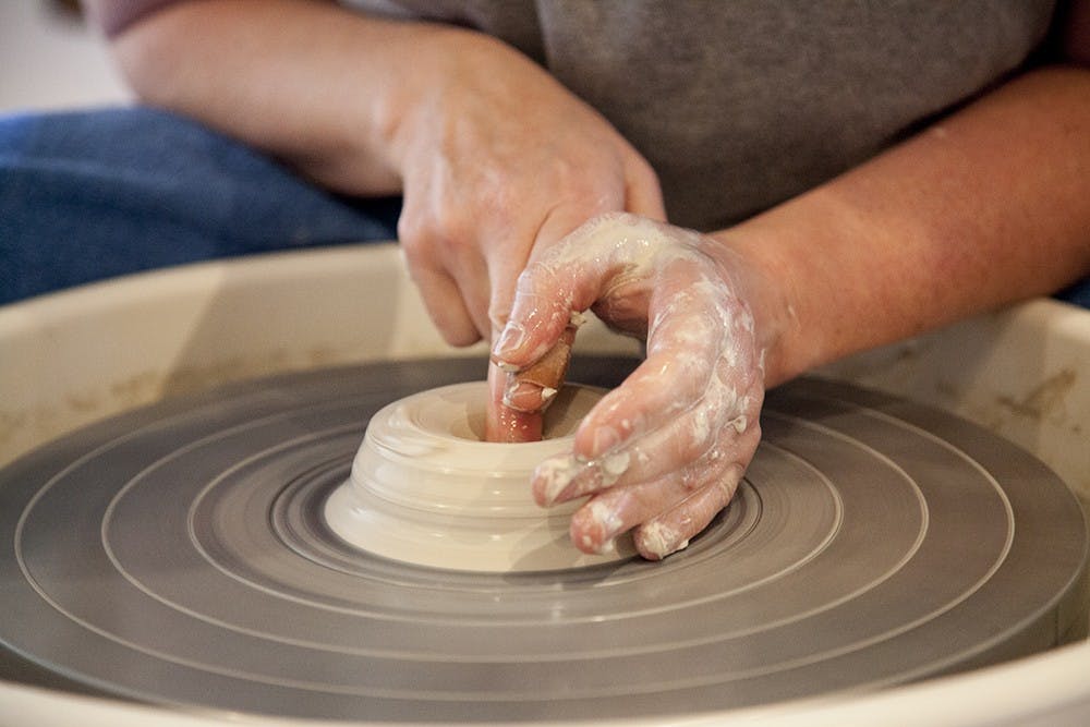 Rebecca Lowery is a Bloomington potter who works in a studio in her garage.  She threw clay on a wheel during a live demonstration at The Venue on Tuesday. 