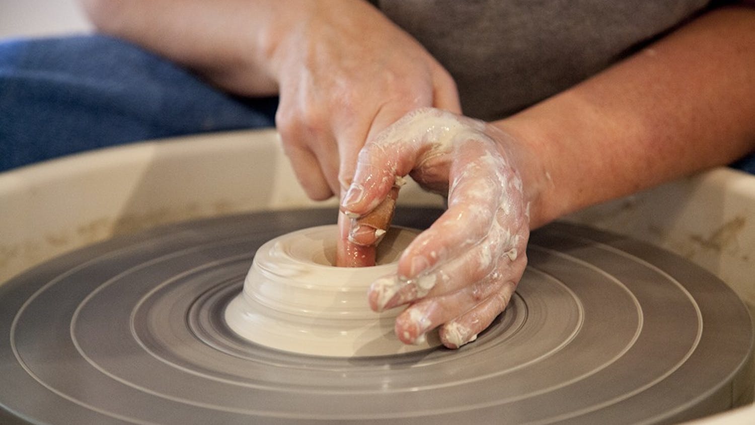 Rebecca Lowery is a Bloomington potter who works in a studio in her garage. She threw clay on a wheel during a live demonstration at The Venue on Tuesday.