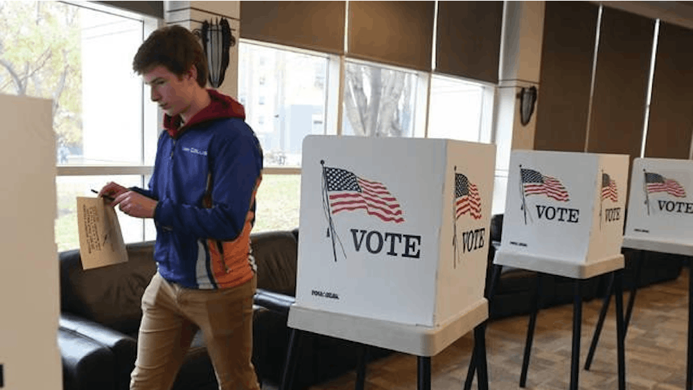 Iowa State University freshman Ian Collis leaves a ballot box Nov. 5, 2019, after casting his vote at Iowa State University&#x27;s Buchanon Hall.