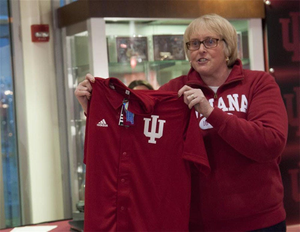 GLBTAA board member Cindy Stone holds a jersey before the Pride Day event at Assembly Hall last year. 