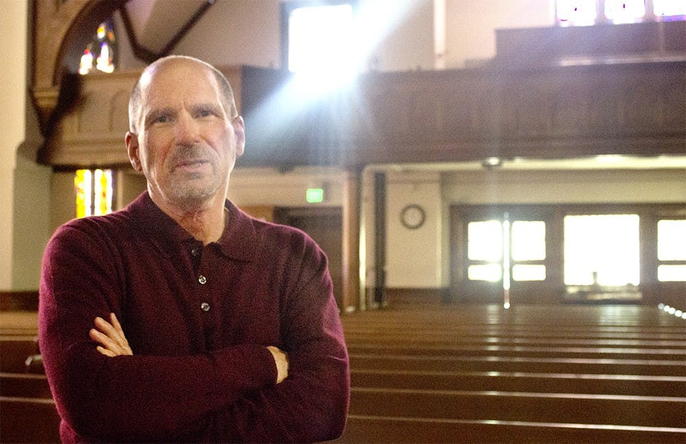 Mark Fenstermacher, the lead pastor of First United Methodist Church, stands in the sanctuary Tuesday afternoon. The church has one male pastor and two female pastoral leaders. 