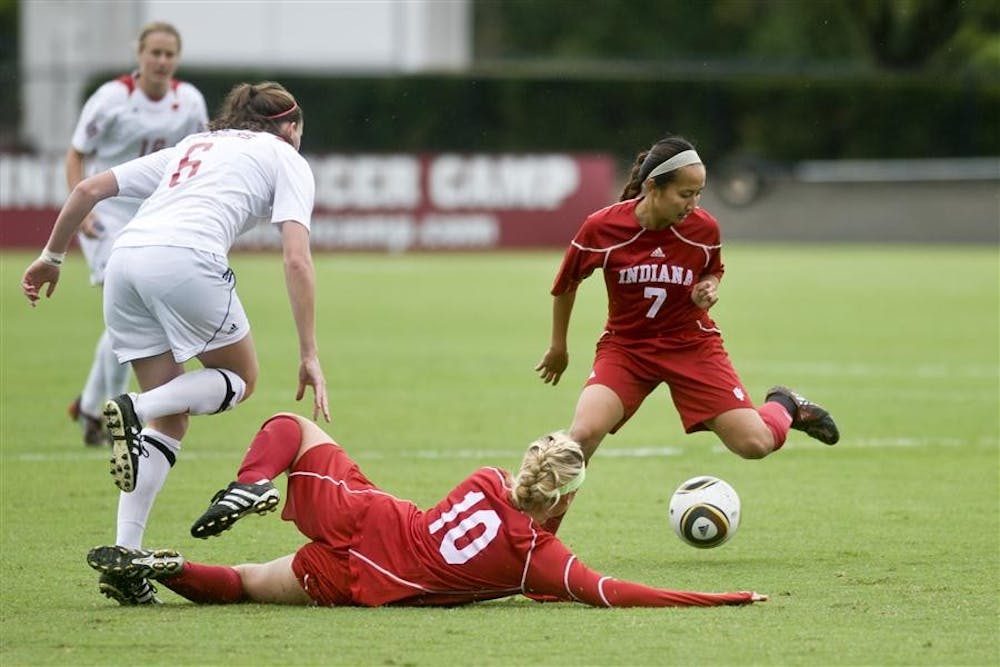 Freshman forward Rebecca Candler and freshman midfielder Lisa Nouanesengsy disposess Wisconsin's Meghan Flannery during IU's 1-0 overtime loss to the Badgers on Sunday at Bill Armstrong Stadium.