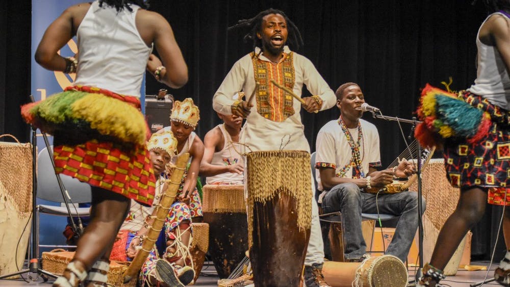 Samuel Malangira leads the dancers and the band during a performance by Dance of Hope. The group performed as part of the Lotus Blossoms free public event series.