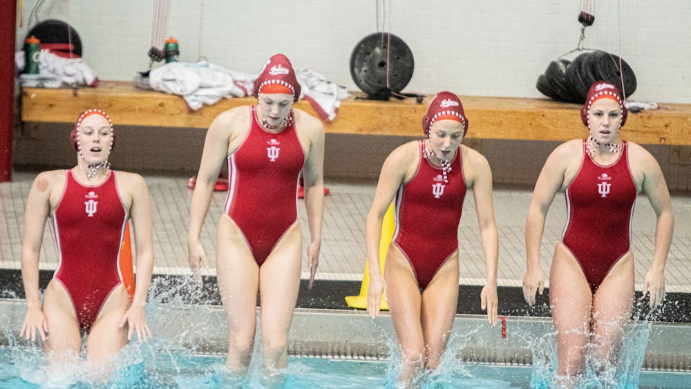 The Hoosiers water polo team jumps into the water prior to its April 13, 2021, match against UCLA. Indiana will travel to Cambridge, Massachusetts, for a four-game weekend at the Harvard Invitational.
