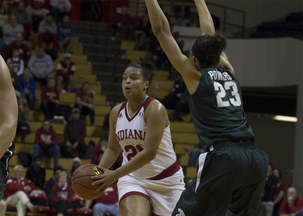 Junior guard Alexis Gassion moves to pass the ball around a Michigan State player on Wednesday night at Assembly Hall. The Hoosiers won the game 85-61.