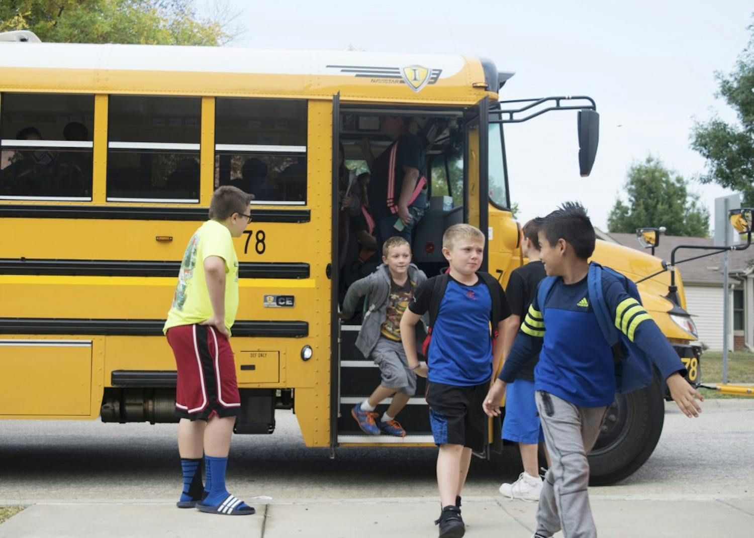 Students disembark a school bus at the Boys and Girls Crestmont Club after school in September. The Monroe County Community School Corporation officially terminated its contract with the Michigan-based Auxilio Services on Oct. 13 and moved to an in-house bus system.