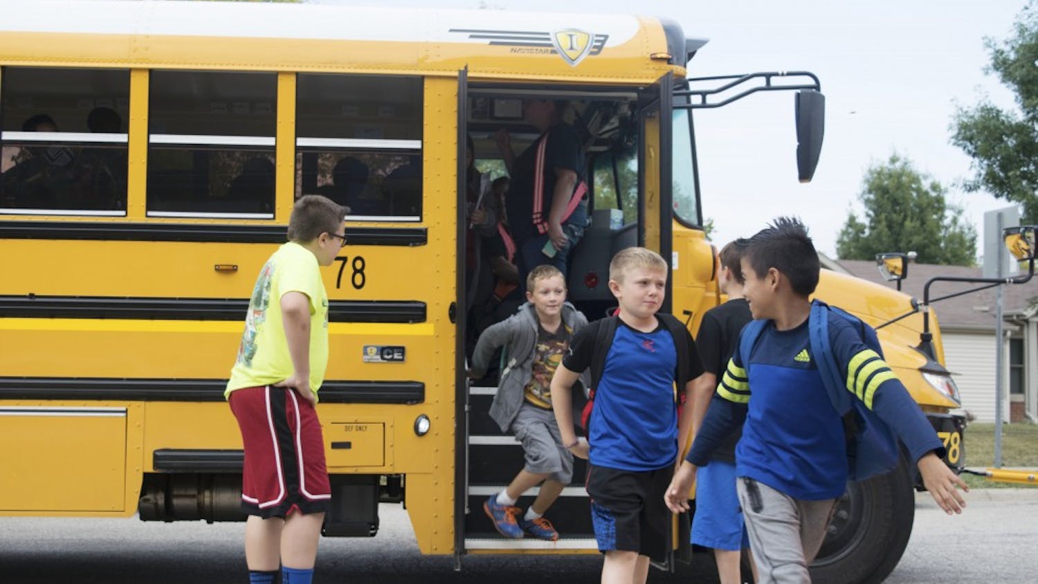 Students disembark a school bus at the Boys and Girls Crestmont Club after school in September. The Monroe County Community School Corporation officially terminated its contract with the Michigan-based Auxilio Services on Oct. 13 and moved to an in-house bus system.