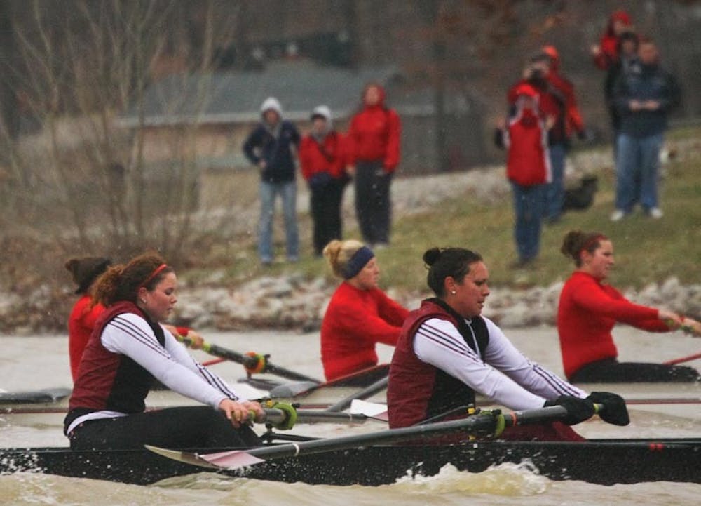 IDS FILE PHOTO
Members of the Hoosier rowing team race against Louisville March 22 at Lake Lemon, while friends and families watch from the shoreline.