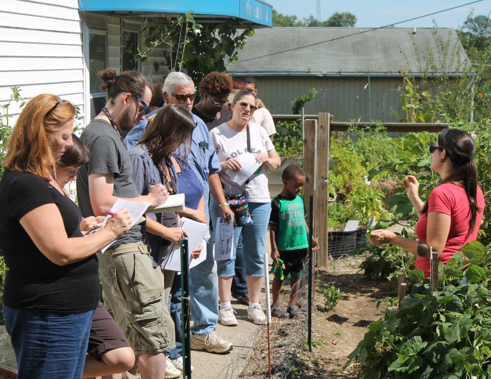 Stephanie Salomon shows the class the difference between a simple and a compound leaf in the Mother Hubbard's Garden.