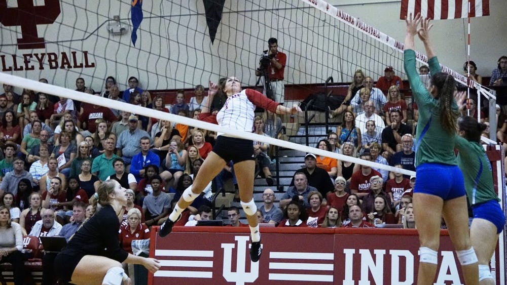 Senior outside hitter Jessica Leish jumps up for a kill while sophomore defensive specialist Meaghan Koors stays by for support. Leish is the only senior on this year's IU volleyball roster, and will be one of two players honored by the Hoosiers during Senior Night later this week.&nbsp;