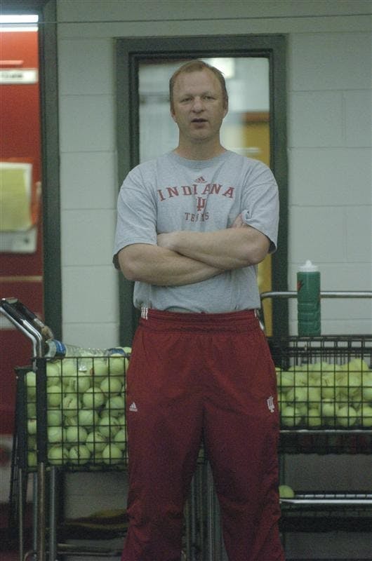 IU Mens tennis coach Randy Bloemendaal watches the mens tennis team practice Tuesday afternoon at the IU Tennis center. 