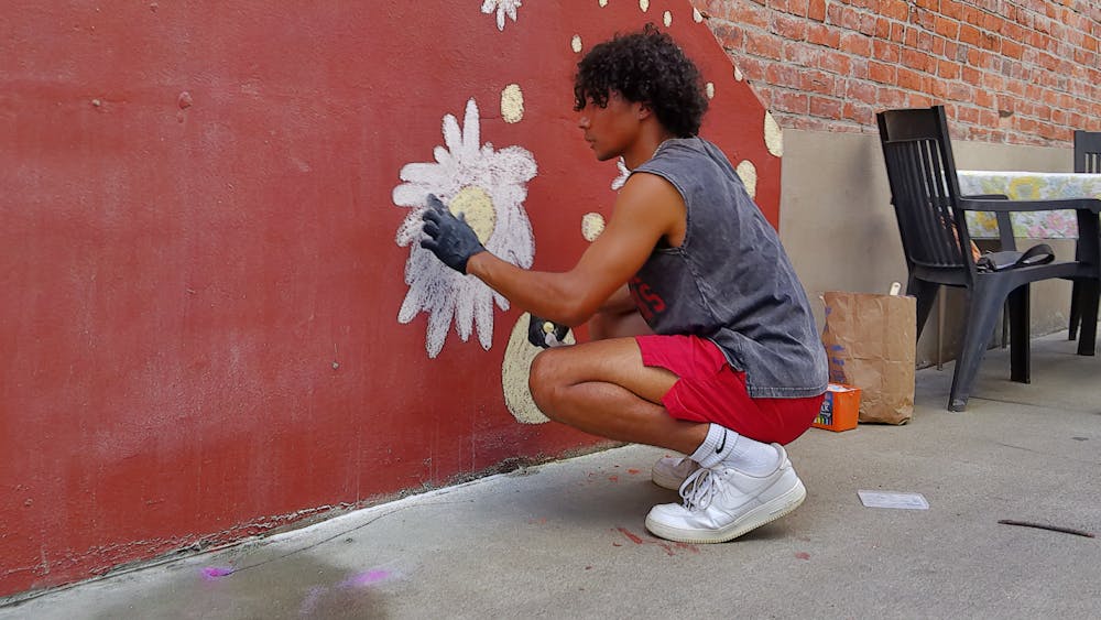 Caleb Poer paints a temporary mural June 2, 2023, at First Friday Gallery Walk. &quot;Paint Bloomington!&quot; is an event that consists of an art competition, free classes, demonstrations, music and storytelling. 