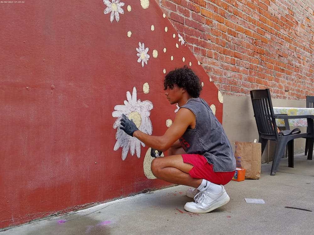 Caleb Poer paints a temporary mural June 2, 2023, at First Friday Gallery Walk. &quot;Paint Bloomington!&quot; is an event that consists of an art competition, free classes, demonstrations, music and storytelling. 