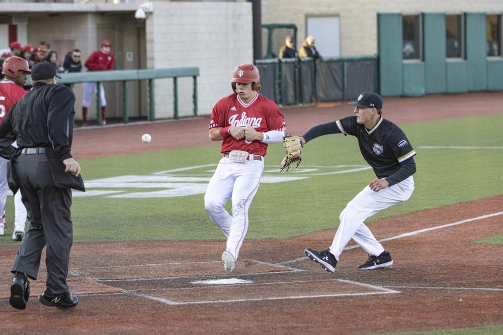<p>Freshman outfielder Carter Mathison rushes to home plate before the throw gets to the Purdue Fort Wayne defender March 9, 2022, at Bart Kaufman Field. Indiana beat University of Cincinnati 11-3. </p>