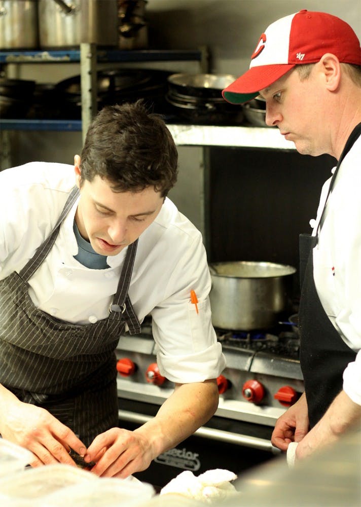 Michael Blagg, left, executive chef, prepares one of the main courses with Ratchie Bowling, sous chef on Wednesday at Restaurant Monet. Monet is a new restaurant opened January which provides organic, local grown ingredients with wine list.  