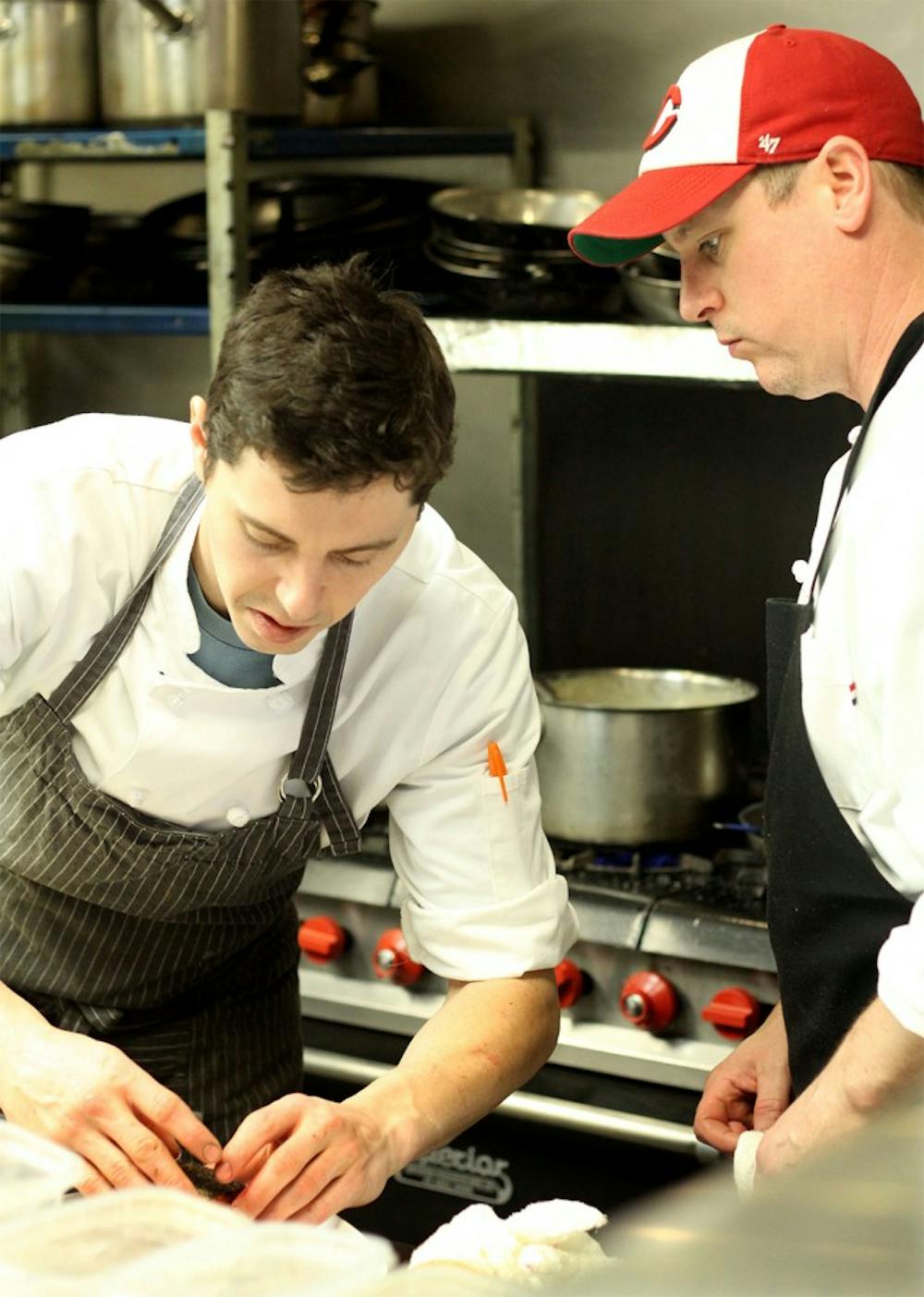 Michael Blagg, left, executive chef, prepares one of the main courses with Ratchie Bowling, sous chef on Wednesday at Restaurant Monet. Monet is a new restaurant opened January which provides organic, local grown ingredients with wine list.  