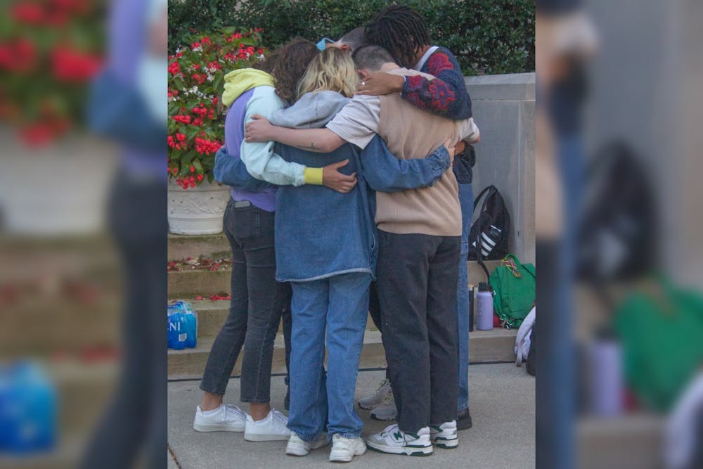 <p>Family and friends of Nate Stratton share a hug during a vigil for Stratton on Sept. 22, 2022, at Showalter Fountain. Smith and Gonzalez both said that Stratton&#x27;s infectious smile, fun personality and impact on the IU community will always be remembered.</p>