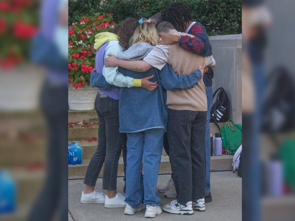 Family and friends of Nate Stratton share a hug during a vigil for Stratton on Sept. 22, 2022, at Showalter Fountain. Smith and Gonzalez both said that Stratton&#x27;s infectious smile, fun personality and impact on the IU community will always be remembered.