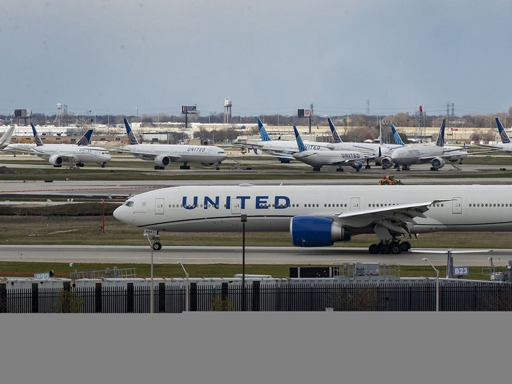 A United Airlines plane taxis by parked United jets on April 14, 2020 at O&#x27;Hare International Airport in Chicago. Due to the omicron variant, many international students have been stuck at home and have been unable to return to IU&#x27;s campus. 