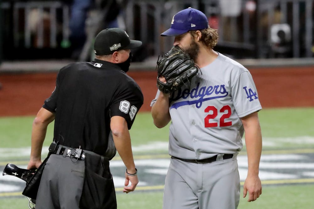 <p>Los Angeles Dodgers starting pitcher Clayton Kershaw talks with the home plate umpire after the first inning against the Atlanta Braves in Game 4 of the National League Championship Series on Oct. 15 at Globe Life Field in Arlington, Texas.</p>