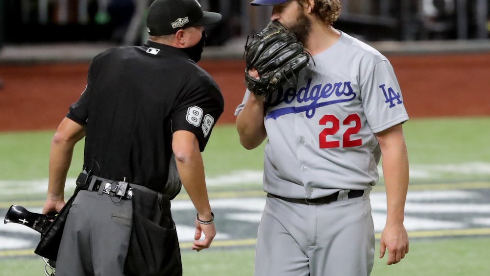 Los Angeles Dodgers starting pitcher Clayton Kershaw talks with the home plate umpire after the first inning against the Atlanta Braves in Game 4 of the National League Championship Series on Oct. 15 at Globe Life Field in Arlington, Texas.