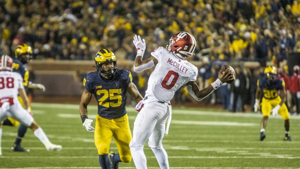 Freshman quarterback Donaven McCulley avoids a sack Nov. 6, 2021 at Michigan Stadium. McCulley completed 10 of his 24 pass attempts against Michigan.