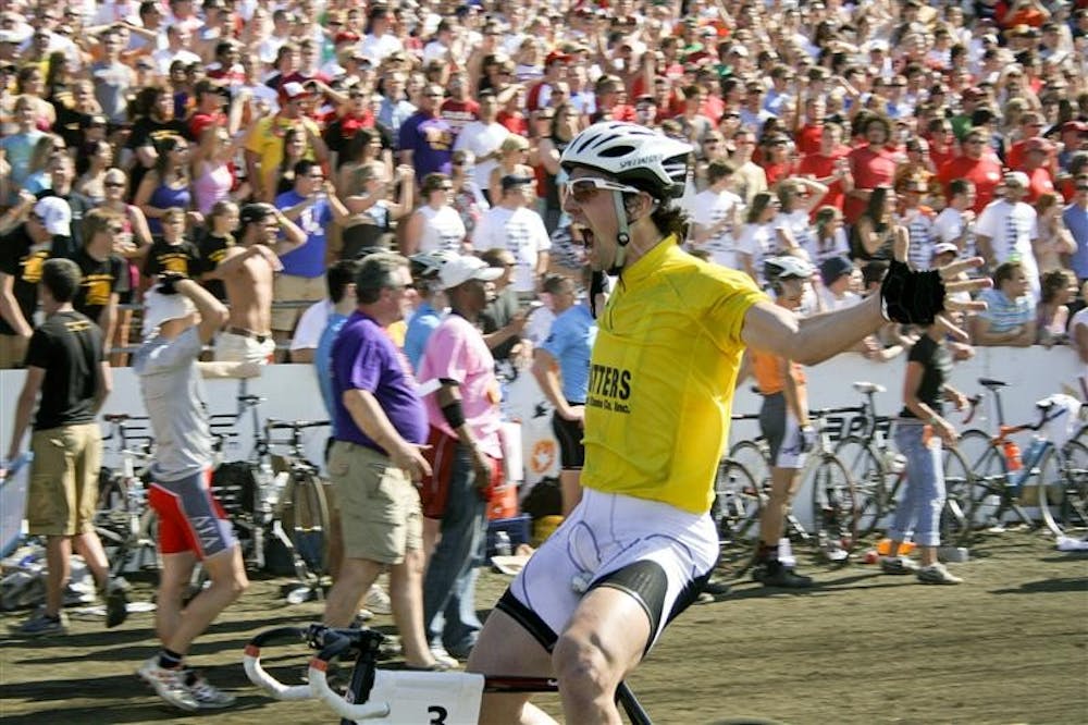 Cutters rider Eric Young celebrates after crossing the finish line and winning in the 59th annual men's Little 500 race on Saturday afternoon at Bill Armstrong Stadium. This marked the third consecutive win for the Cutters.