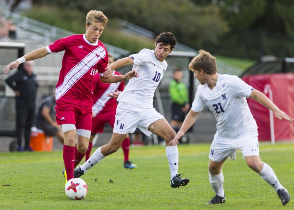 <p>Sophomore Griffin Dorsey breaks away from Northwestern University midfielder Tommy Katsiyiannis on Sept. 26 at Bill Armstrong Stadium. Dorsey scored IU’s second goal of night in the 86th minute after Justin Rennicks’ goal earlier in the game. IU defeated NU, 2-1.</p>