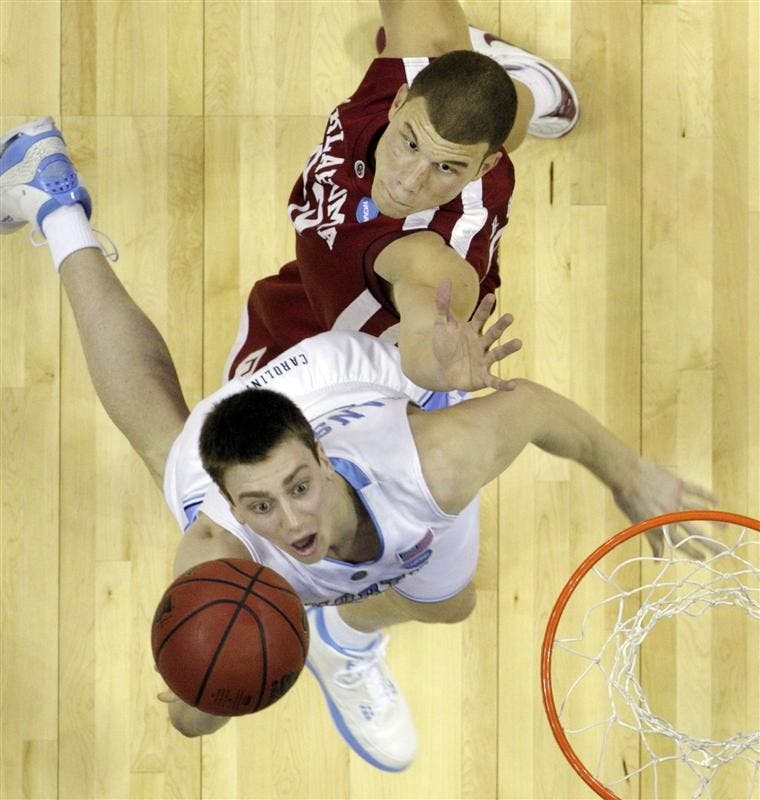 North Carolina forward Tyler Hansbrough, bottom, scores as Oklahoma forward Blake Griffin defends during the first half of the men's NCAA tournament South Regional championship college basketball game Sunday in Memphis, Tenn. North Carolina won 72-60.