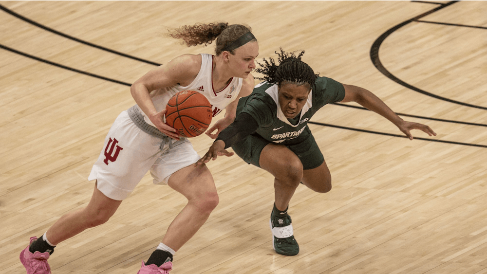 Junior guard Grace Berger dribbles around a defender March 11 in the quarterfinals of the Big Ten women's basketball tournament at Bankers Life Fieldhouse in Indianapolis. Berger was named one of IU's Athletes of the Year on Thursday.