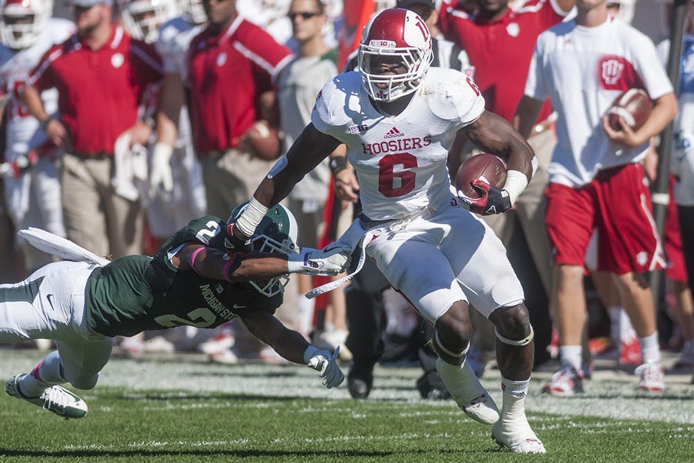 Then-sophomore running back Tevin Coleman runs past a Spartan defender during IU's game against Michigan State on Oct. 12, 2013, at Spartan Stadium.