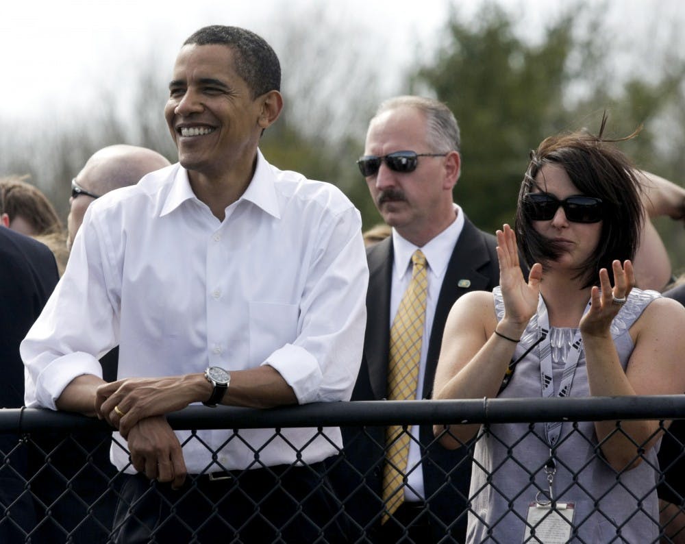 <p>Then-Sen. Barack Obama watches pace laps with IU Student Foundation director Jenny Bruffey before the start of the women's Little 500 bicycle race in 2008 at Bill Armstrong Stadium. Obama walked around the track and greeted each team before the race.</p>