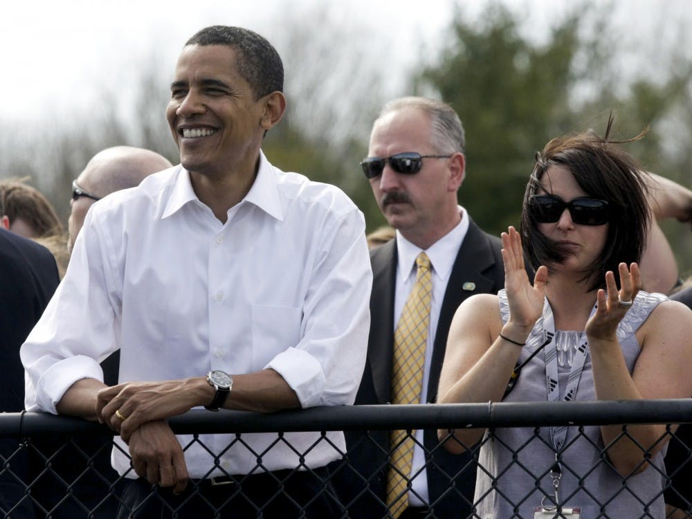 Then-Sen. Barack Obama watches pace laps with IU Student Foundation director Jenny Bruffey before the start of the women's Little 500 bicycle race in 2008 at Bill Armstrong Stadium. Obama walked around the track and greeted each team before the race.