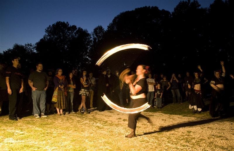 A performer for the The Dark Side Tribal Belly Dance Goup performs in front of a crowd of attentive spectators on Thursday night at the Starlight Drive In Theatre. The audience hissed and hawed in appreciation as the group snaped and claped to the beat.