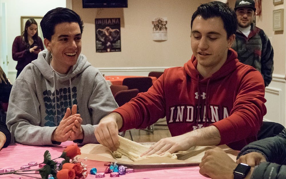 Freshmen Eban Stern (left) and Jake Trachtenberg prepare challah dough at the Hillel on Monday.  The Hillel hosted a challah baking event aimed towards raising breast cancer awareness.
