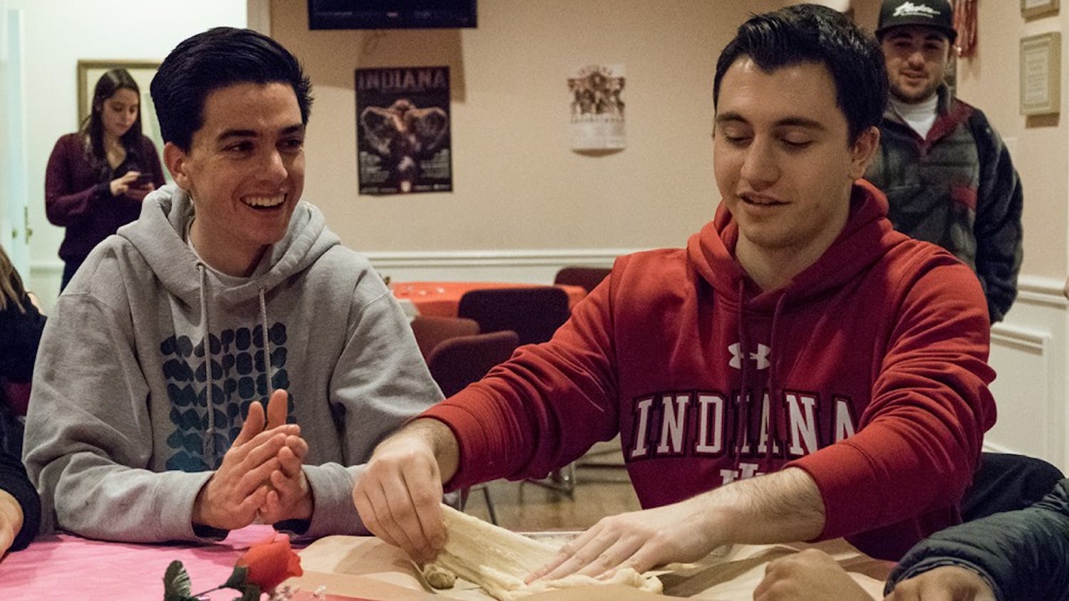 Freshmen Eban Stern (left) and Jake Trachtenberg prepare challah dough at the Hillel on Monday.  The Hillel hosted a challah baking event aimed towards raising breast cancer awareness.