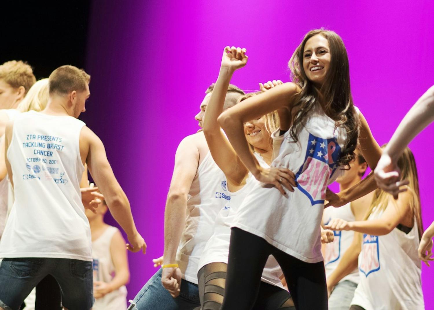 Members of greek life dance on stage Friday night at the Auditorium to kick off Zeta Tau Alpha's Big Man on Campus talent show. The sorority raised $182,116.13 for breast cancer research and awareness through programming like Big Man on Campus.