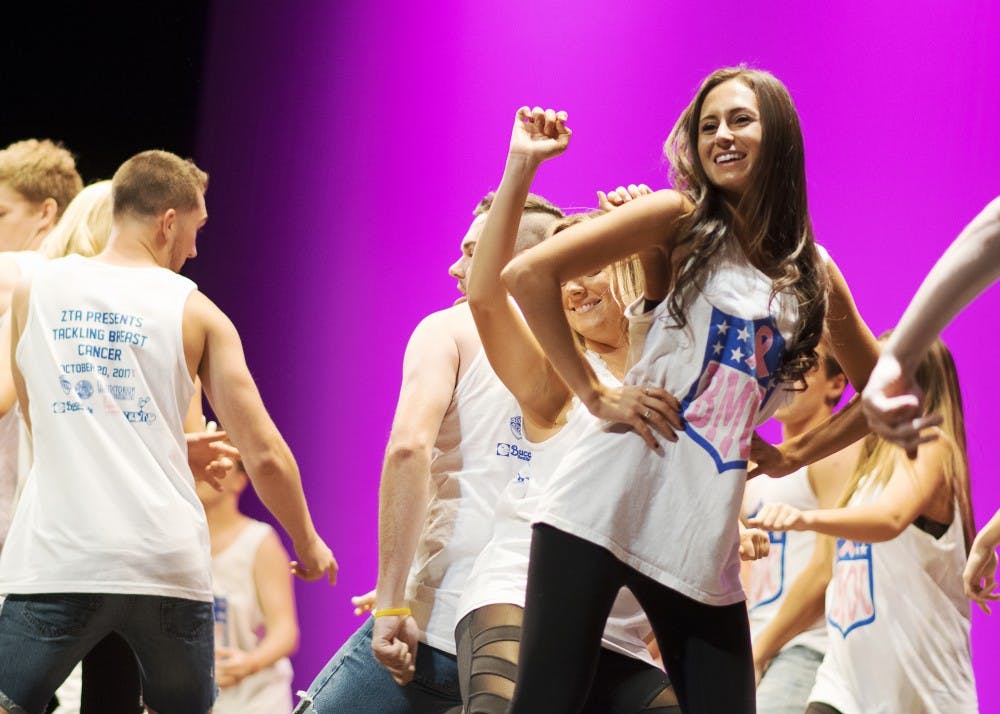 <p>Members of greek life dance on stage Friday night at the Auditorium to kick off Zeta Tau Alpha's Big Man on Campus talent show. The sorority raised $182,116.13 for breast cancer research and awareness through programming like Big Man on Campus.</p>