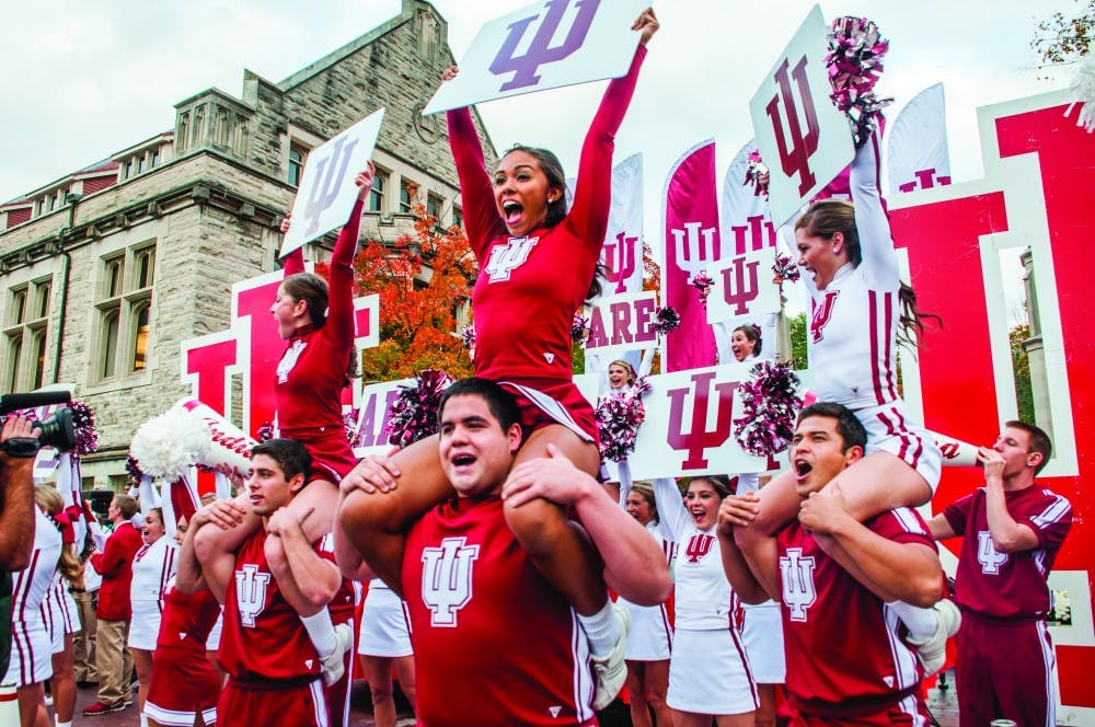 Kylie CisneyCheerleaders rally in front of the Sample Gates during the Oct. 17, 2014 homecoming parade.