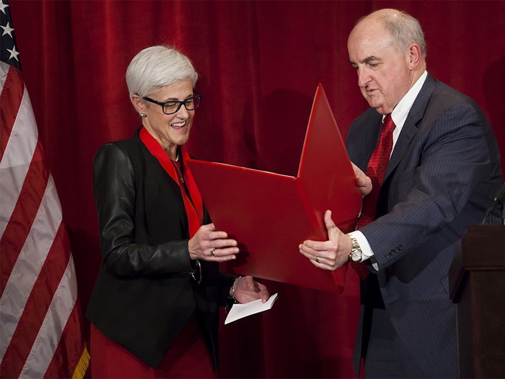 Indiana University President Michael A. McRobbie, right, bestows the President's Medal on IU Senior Vice President, Chief Financial Officer and Treasurer MaryFrances McCourt during a farewell reception in her honor on Mar. 10, 2016, at the IU Auditorium.