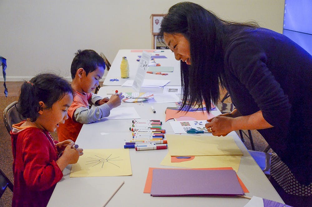 Alexandra Jia and her older brother Will Jia participate in the "Family Craft Day: Inspired by the Amazon" event hosted by the The Mathers Museum of World Cultures on Sunday.