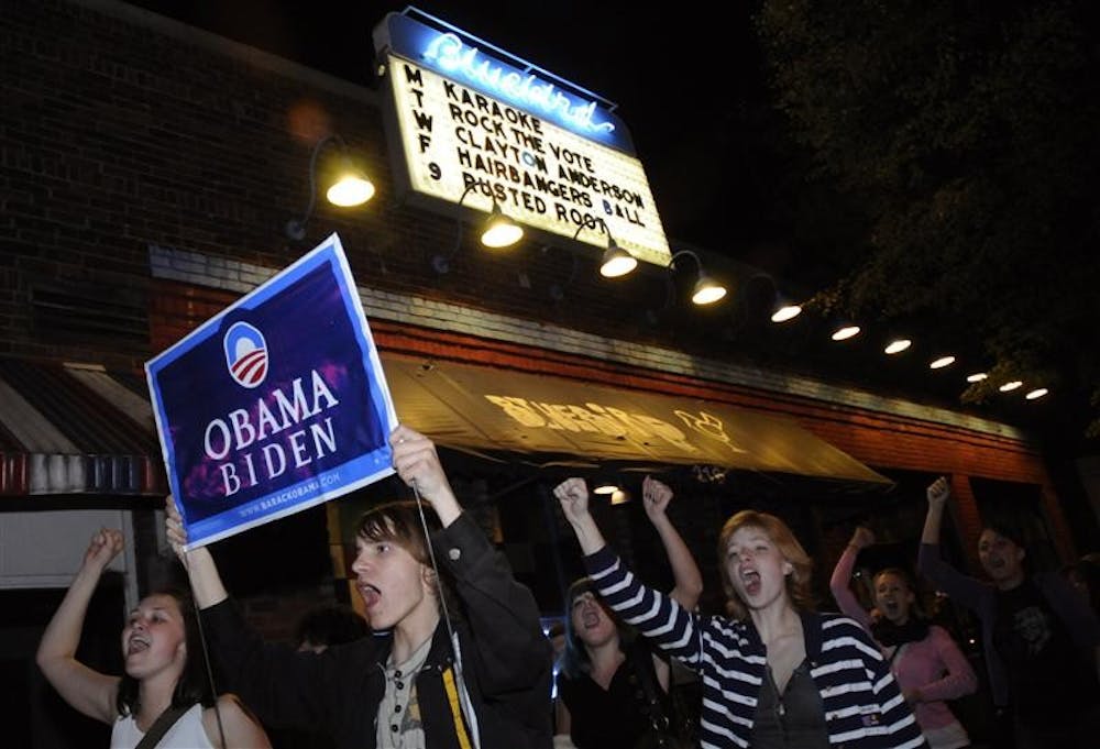 Students march early Wednesday past the Bluebird on Walnut Avenue after it was announced that Barack Obama had won the presidency. Many Obama supporters gathered at the restaurant to watch election coverage. Marchers started at Collins Living-Learning Center and marched to Showalter Fountain, Kirkwood Avenue and ended at the Obama office at 9th Street and Walnut Avenue.