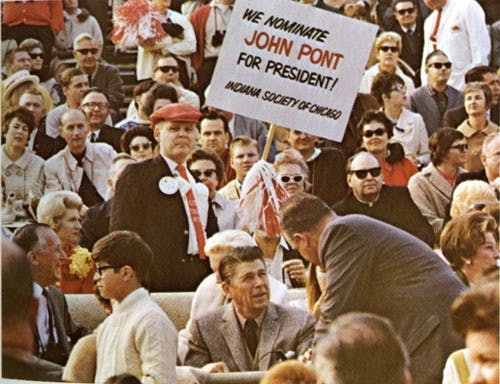 An IU fan holds a sign supporting John Pont behind California Gov. Ronald Reagan during the 1968 Rose Bowl game.
