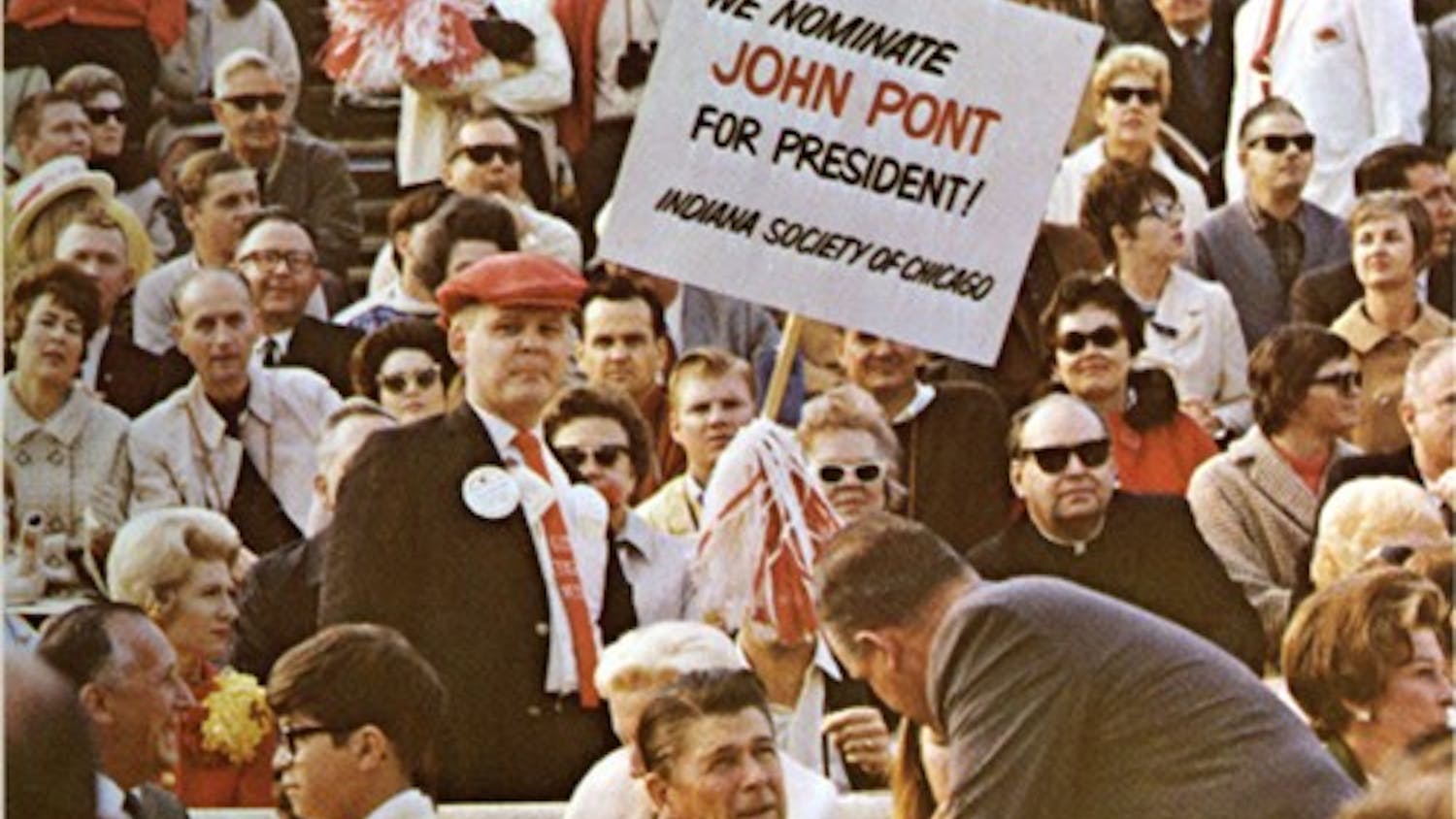 An IU fan holds a sign supporting John Pont behind California Gov. Ronald Reagan during the 1968 Rose Bowl game.
