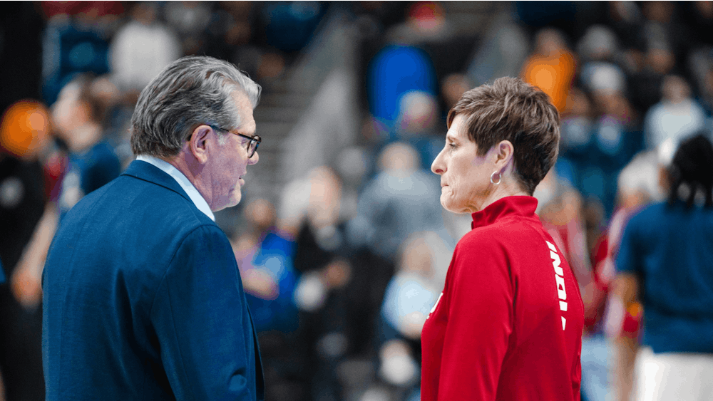 Head coaches Teri Moren and Geno Auriemma shake hands and talk before the Sweet Sixteen game Mar. 26, 2022, at Total Mortgage Arena in Bridgeport, Conn. Indiana lost 75-58 against the University of Connecticut.