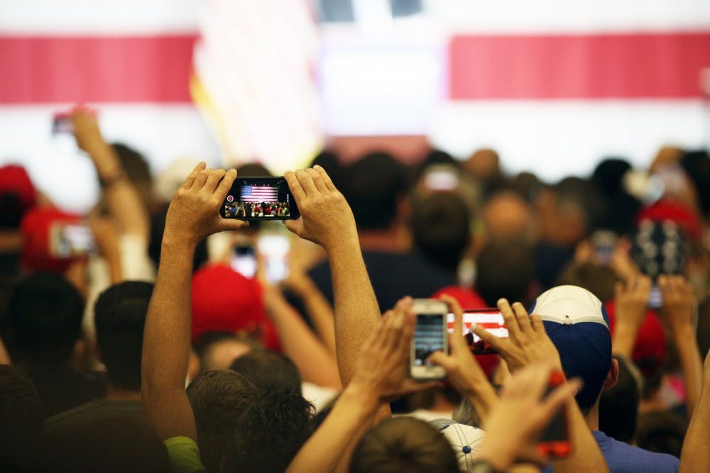 An audience member takes a picture as Donald Trump, republican presidential candidate, speak during a Trump rally in Westfield, Ind. on Tuesday evening.