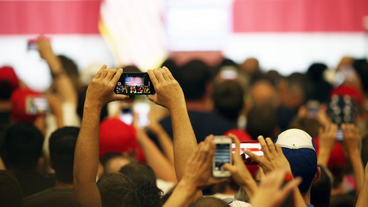 An audience member takes a picture as Donald Trump, republican presidential candidate, speak during a Trump rally in Westfield, Ind. on Tuesday evening.