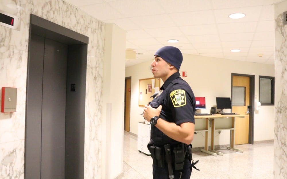 Full-time officer Pablo Padilla awaits an elevator at Willkie Residence Center. One of IUPD's most common calls involves an odor of marijuana. 