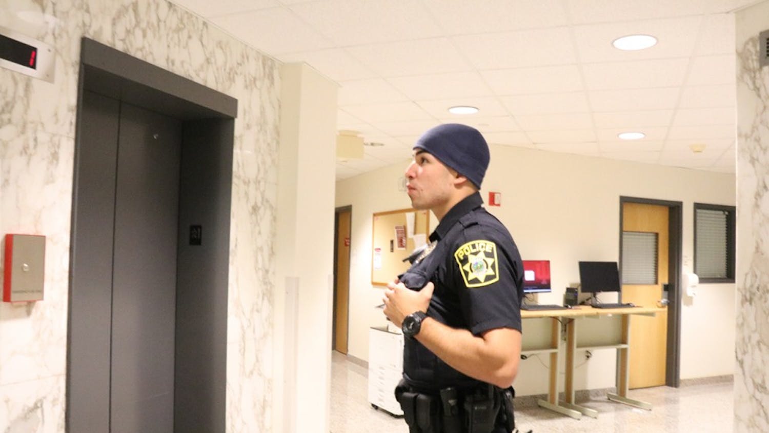 Full-time officer Pablo Padilla awaits an elevator at Willkie Residence Center. One of IUPD's most common calls involves an odor of marijuana.